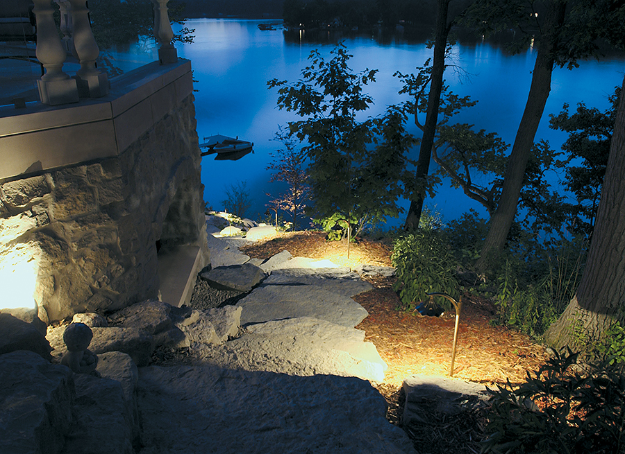 a path at night with rock steps illuminated by path lights