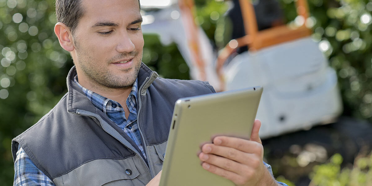 This image shows a green industry professional using landscape design software on a tablet.